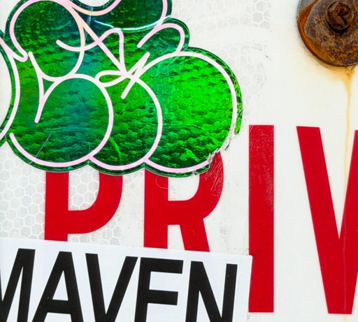 Green graffiti layered over red and black printed lettering.