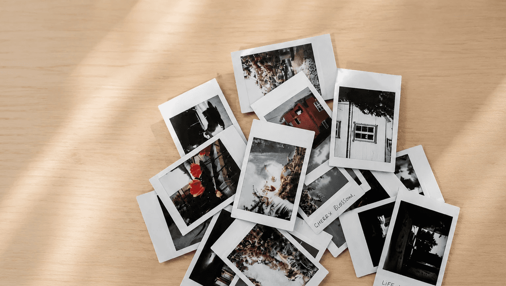 A collection of printed photographs, used as references for preserving memories.