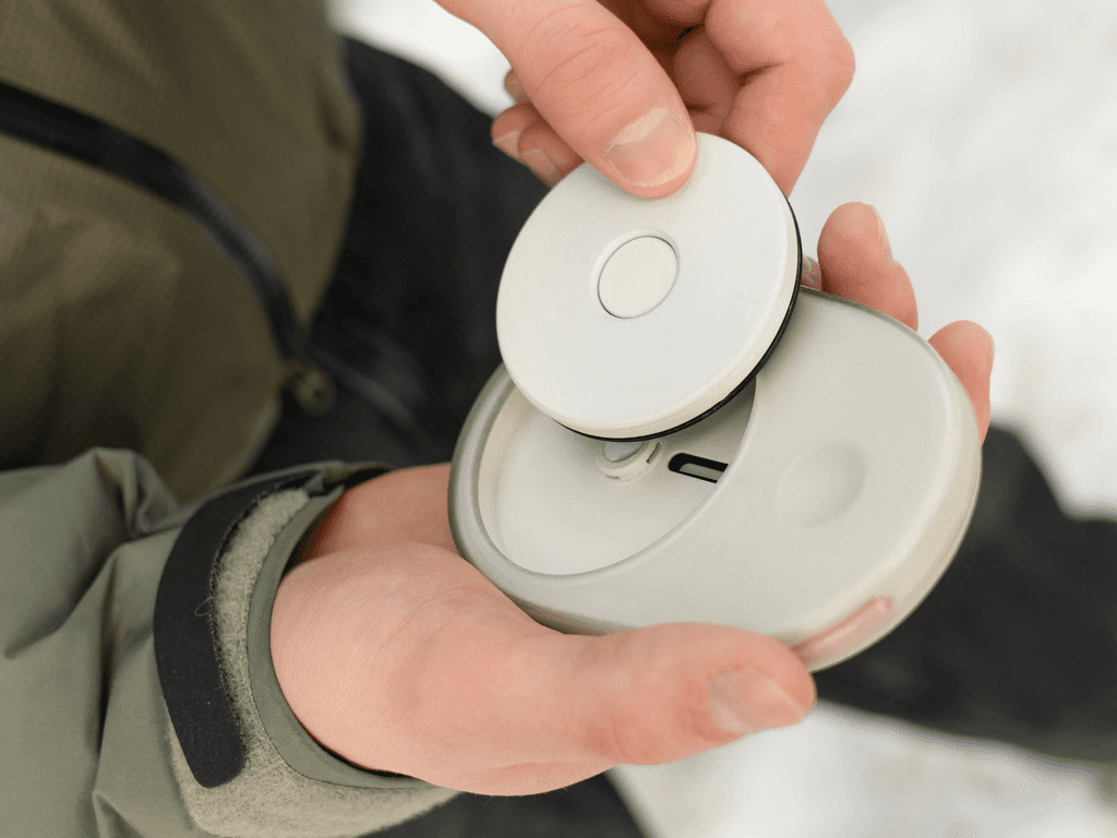 A person holds the recorder and inserts a sound-memory disc.