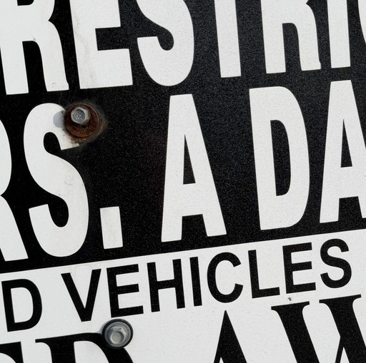 Tightly cropped black lettering from a parking-restriction sign.
